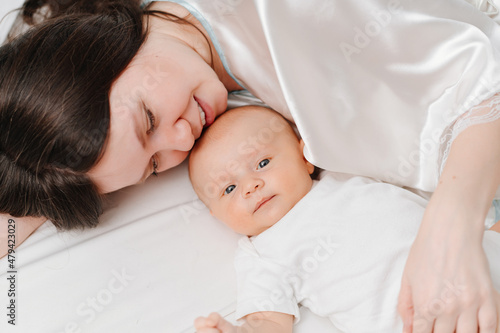 mom lies with the baby in bed. the happiness of motherhood. 
