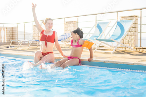 Happy mother and daughter in the swimming pool at the leisure center