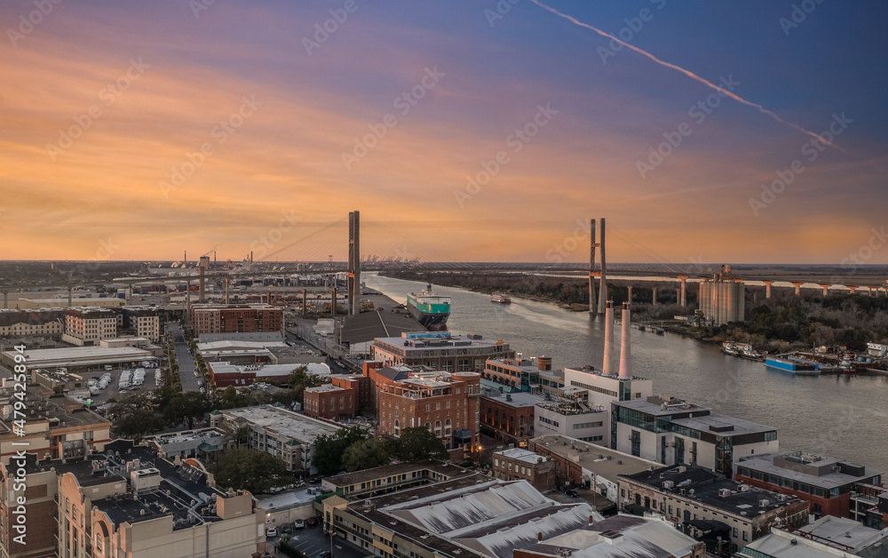  The Talmadge Memorial Bridge is a Cable-stayed bridge or Cantilever bridge in the United States spanning the Savannah River between downtown Savannah, Georgia and Hutchinson Island with sunset sky