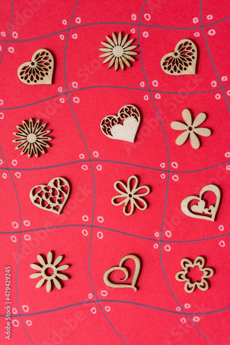 fancy wooden hearts and floral shapes on red paper grid