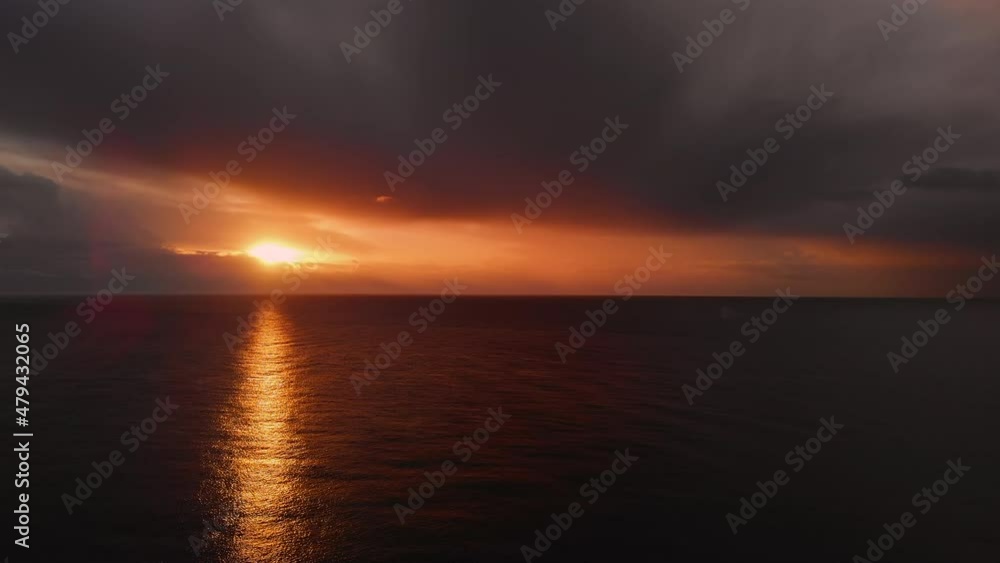 Picturesque sunrise over calm Mediterranean Sea. Bright colourful sunset with gloomy cloudy sky over the smooth ocean, horizon over water. Beauty in nature concept. Spain Picturesque sunrise over calm Mediterranean Sea. Bright colourful sunset with gloomy cloudy sky over the smooth ocean, horizon over water. Beauty in nature concept. Spain