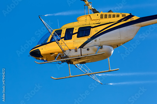 Close-up of yellow crop spraying helicopter