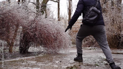 Man in winter dress slip on sidewalk with ice closeup. 