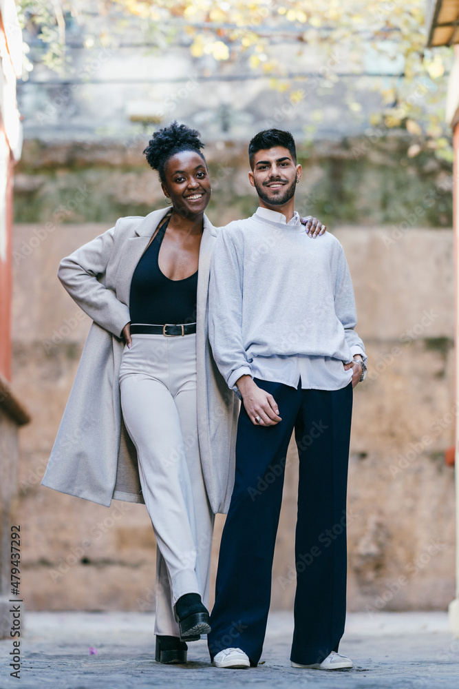 Two models of different ethnicities posing together on the street Two models of different ethnicities posing together on the street