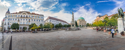 Panoramic view of Szechenyi square with the former mosque turned roman catholic church , trinity statue and other famous building in downtown Pecs photo