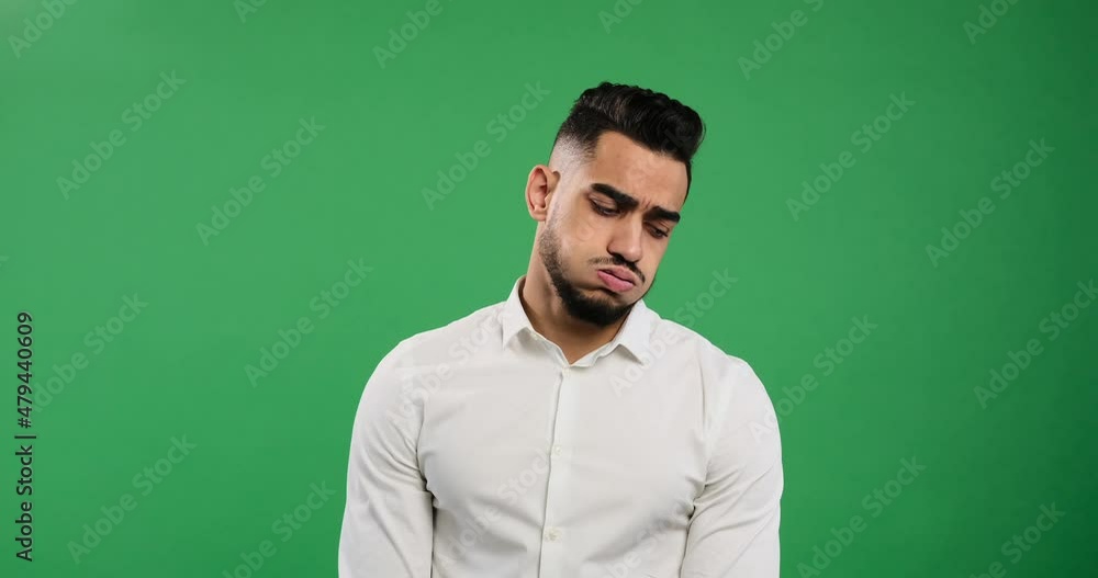 Disappointed man shaking his head over green chroma key background Disappointed man shaking his head over green chroma key background