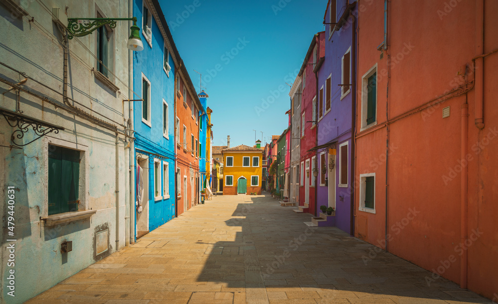 Obraz premium Burano island canal, colorful houses and boats in the Venice lagoon. Italy
