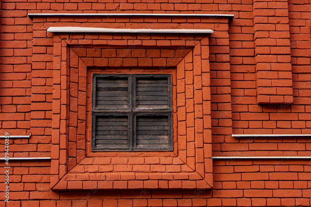 Closed shutters on a red brick wall