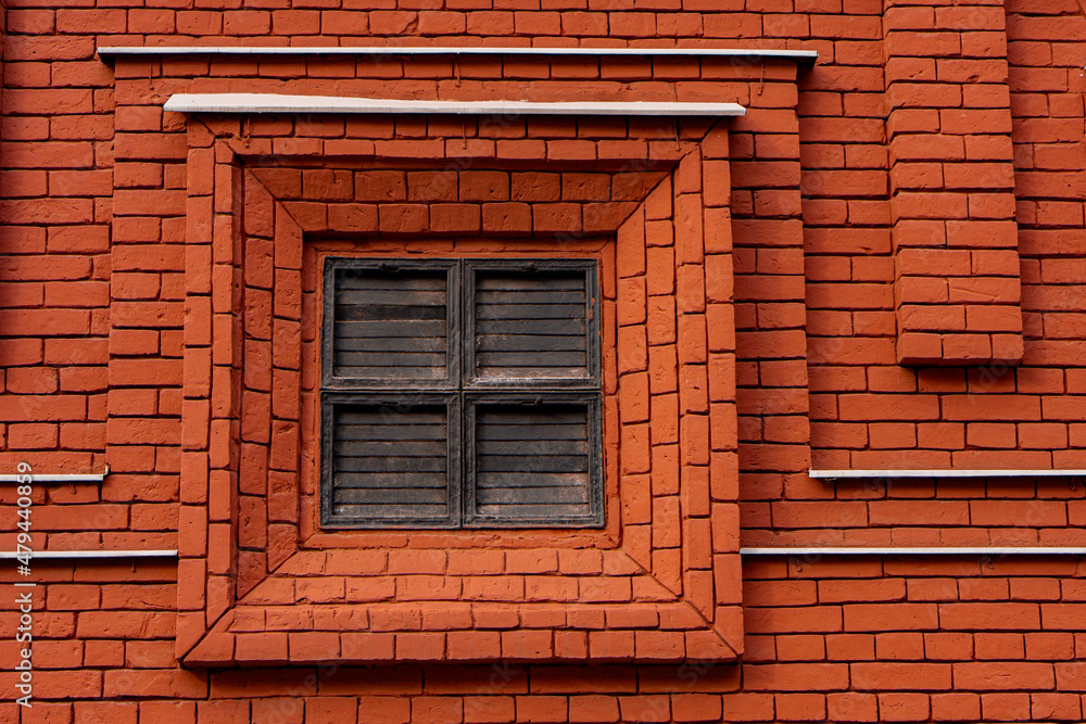 Closed shutters on a red brick wall Closed shutters on a red brick wall