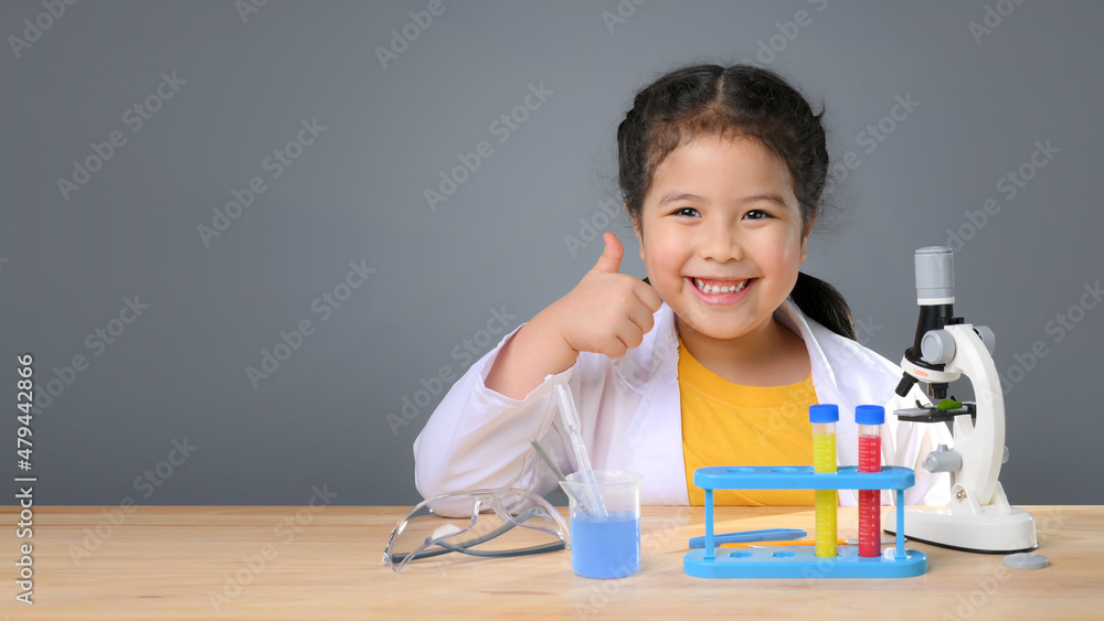 Asian child girl learning science chemistry with test tube making experiment at school laboratory. education, science, chemistry and children concept . Early development of children. Asian child girl learning science chemistry with test tube making experiment at school laboratory. education, science, chemistry and children concept . Early development of children.