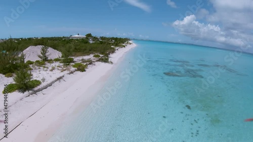 Fly by near a very beautiful coastline and beach of the Caribbean Grand Turk Island. White sandy beach and turquoise water drone shot 4k photo