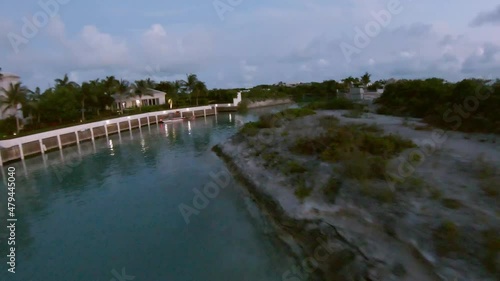 FPV drone shot of resorts and buildings with lush green trees on a beautiful tropical Beach in the Caribbean. On the Turks and Caicos archipelago island 4K photo