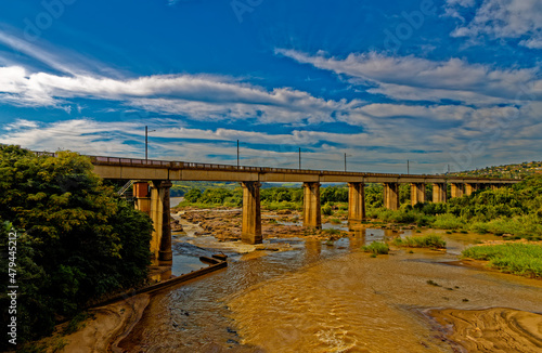 Railway bridge across muddy river
