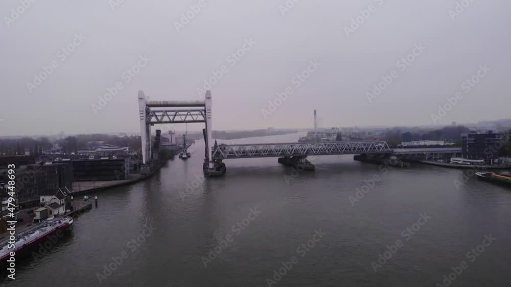 Dordrecht Railway Bridge Near Shipyard By Oude Maas In Dordrecht, South Holland, Netherlands. - aerial forward Dordrecht Railway Bridge Near Shipyard By Oude Maas In Dordrecht, South Holland, Netherlands. - aerial forward