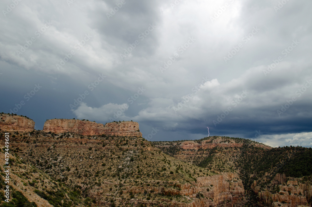 Monsoon storm forming above a desert canyon