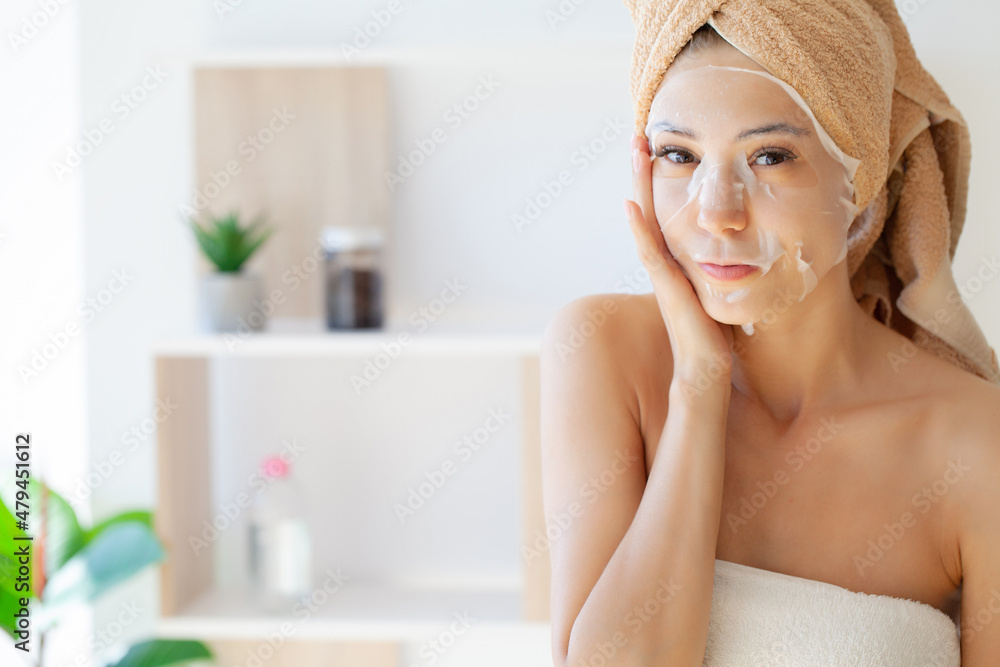 Woman in a mask with a towel on her head skin care cosmetology Woman in a mask with a towel on her head skin care cosmetology