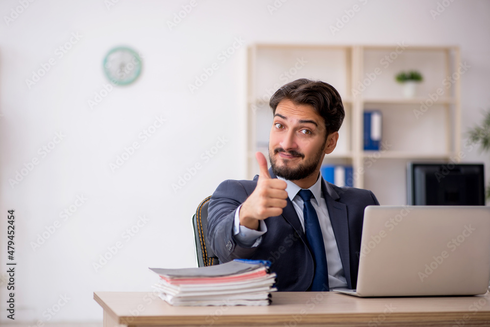 Young male employee working in the office Young male employee working in the office
