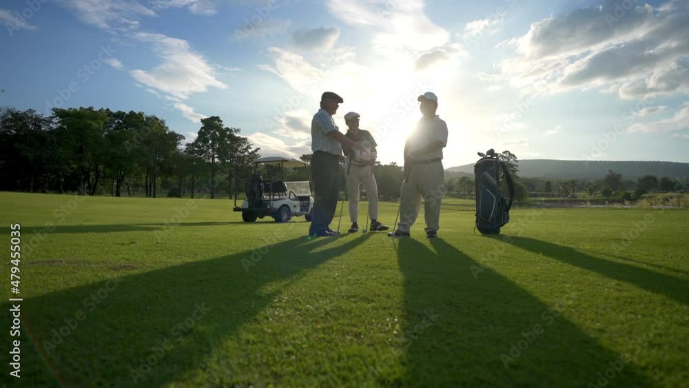 Group of Asian people businessman and senior CEO enjoy outdoor sport lifestyle golfing together at golf country club. Healthy men golfer shaking hand after finish game on golf course at summer sunset Group of Asian people businessman and senior CEO enjoy outdoor sport lifestyle golfing together at golf country club. Healthy men golfer shaking hand after finish game on golf course at summer sunset