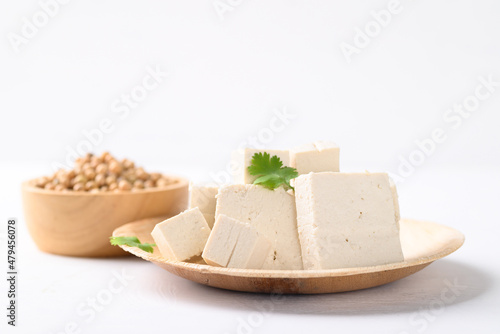Organic tofu on natural plate with white background, Vegan food ingredients in Asian cuisine, plant based