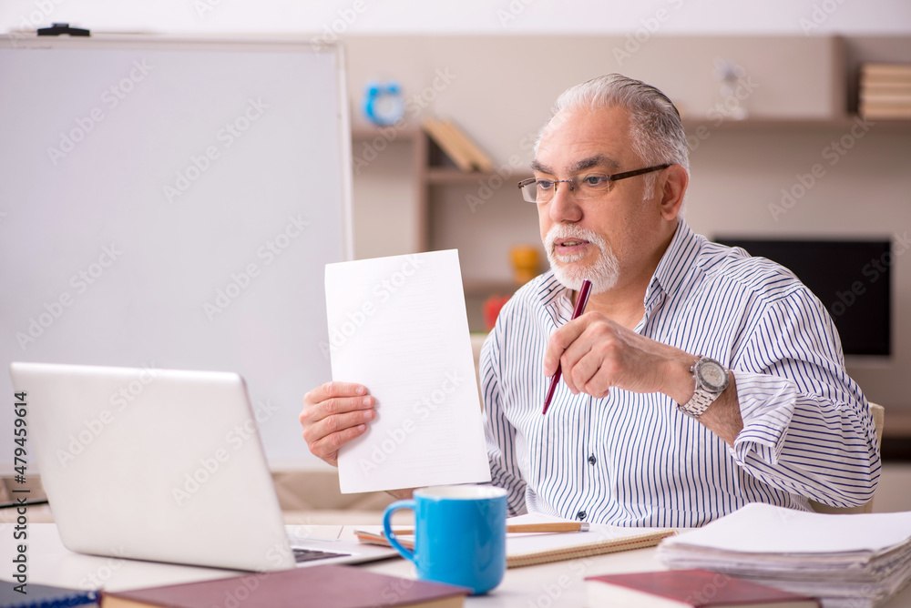 Old male employee working from home during pandemic Old male employee working from home during pandemic