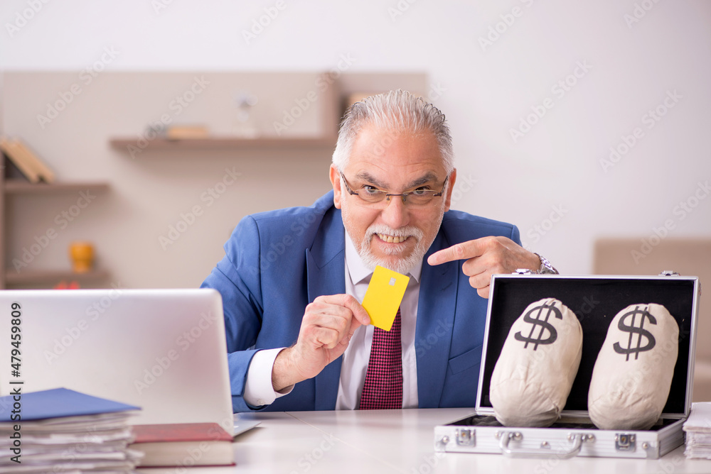 Old male employee in remuneration concept at home Old male employee in remuneration concept at home