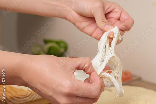 Canvas Print person tearing dairy product or cheese made in mexico oaxaca traditionally it is