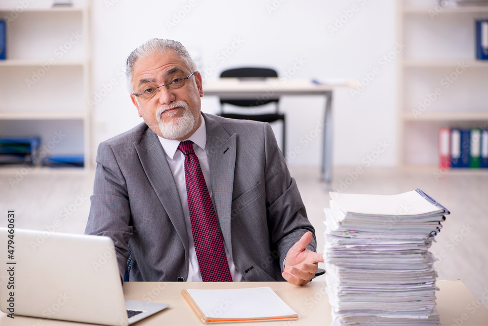 Old male employee and too much work in the office Old male employee and too much work in the office