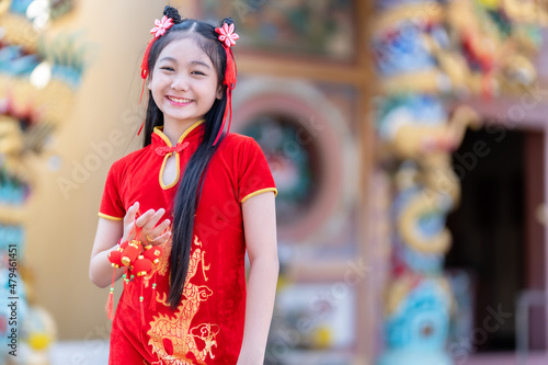 Portrait smiles Cute little Asian woman wearing red traditional Chinese cheongsam decoration hold Small lantern decorations for Chinese New Year