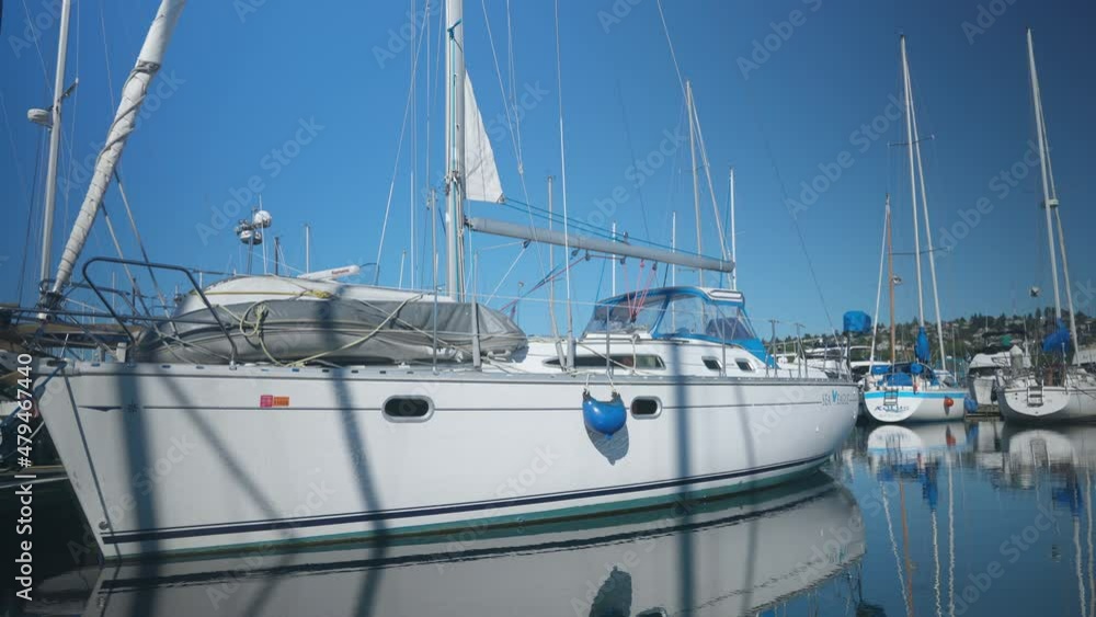 Close up slow motion shot of the boat on a calm ocean water at cruise ship terminals at Seattle, WA USA on a sunny day with many boats behind. 4K Close up slow motion shot of the boat on a calm ocean water at cruise ship terminals at Seattle, WA USA on a sunny day with many boats behind. 4K