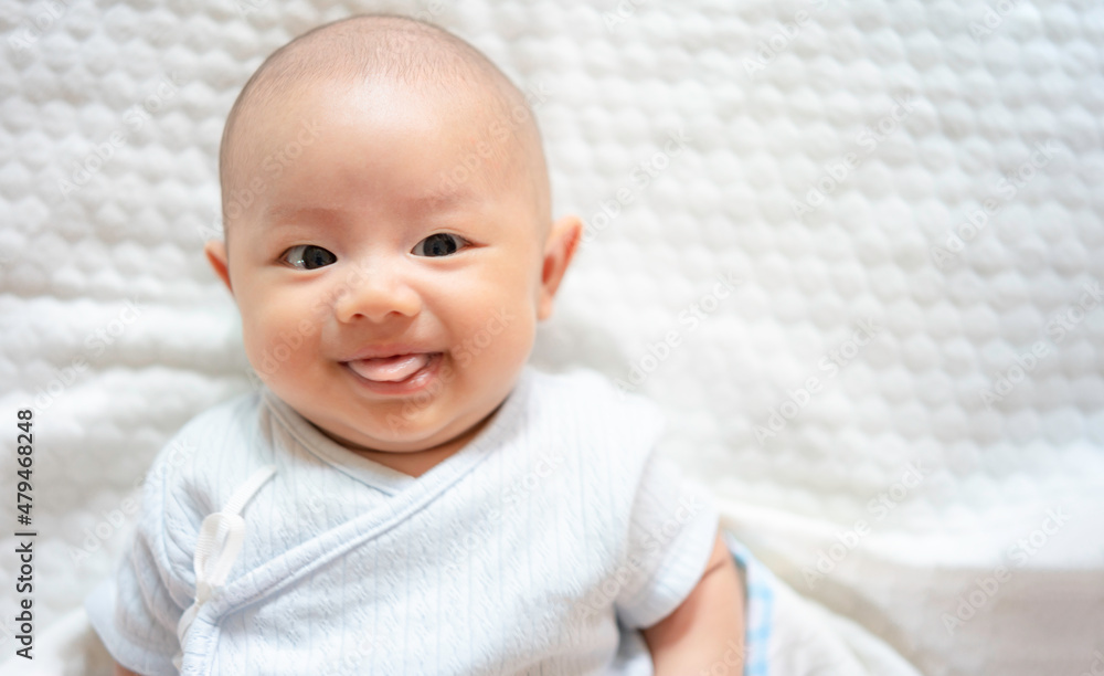 Adorable, Asian newborn. Baby boy looking camera and smile happy face. Little innocent new infant child in first day of life. Mother day concept. Adorable, Asian newborn. Baby boy looking camera and smile happy face. Little innocent new infant child in first day of life. Mother day concept.