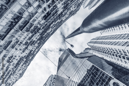 Photography Looking up to high-rise office building and crowded residential building in down