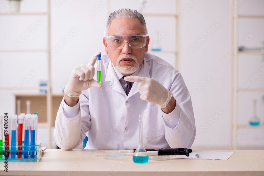 Old male chemist working in the lab Old male chemist working in the lab