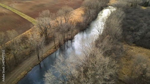 stream in the forest  with agriculture fields 