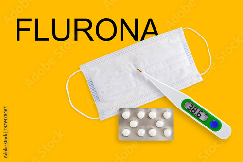 Face masks, thermometer and pills isolated on a yellow background. Covid 19 alpha, beta, gamma, delta, lambda, mu, omicron, deltacron, flurona variants outbreak around the world. photo