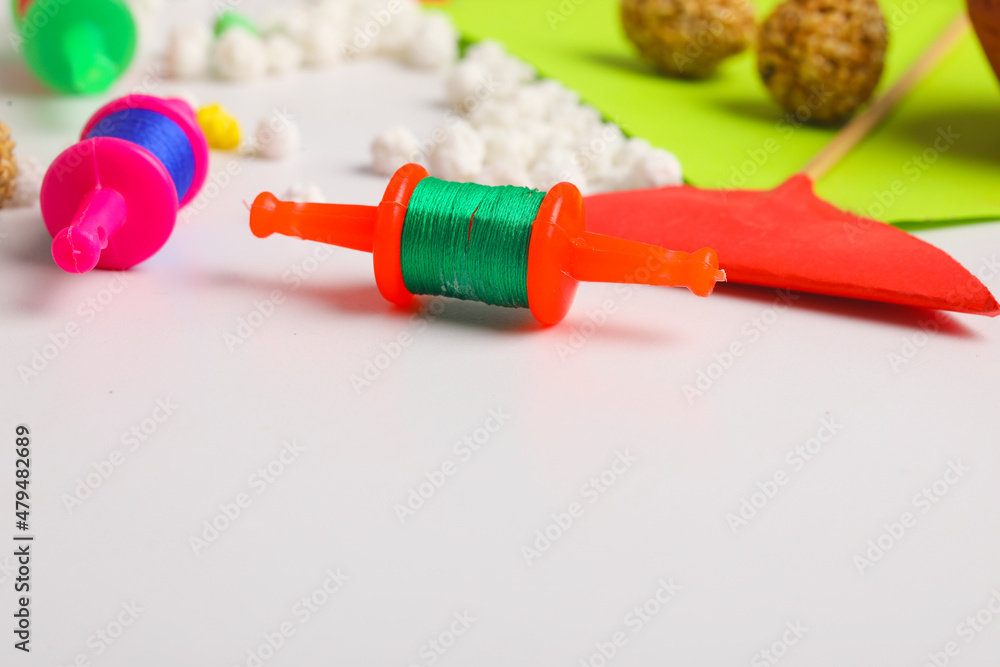 Spool with colourful thread or manjha or dark background. Indian festival makar sankranti concept Spool with colourful thread or manjha or dark background. Indian festival makar sankranti concept