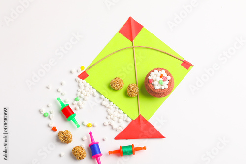Indian festival makar sankranti concept, Colorful kite ,string and sweet sesame seed ball.