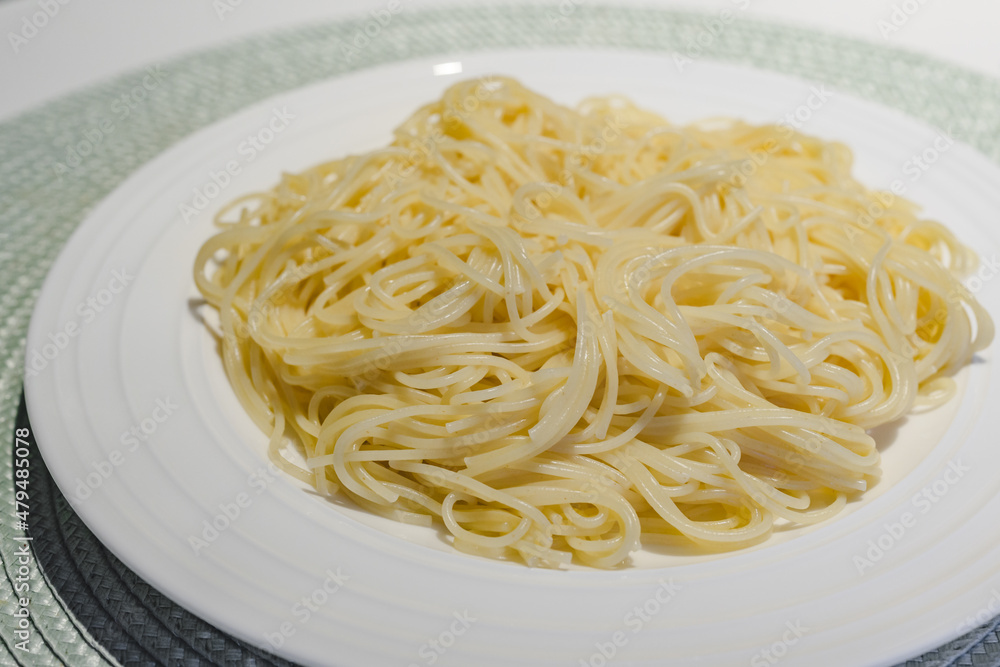 Fresh cooked spaghetti pasta on white plate close up Fresh cooked spaghetti pasta on white plate close up