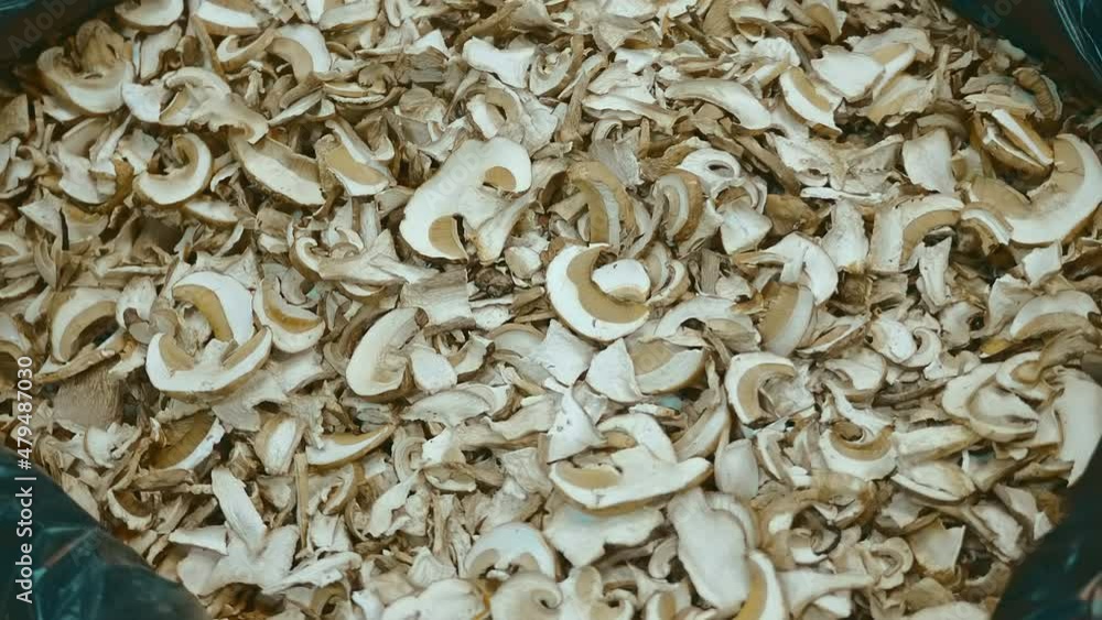 In Russia, the market sells a wide variety of dried mushrooms, which are in heap in large bags. Shot in motion. Closeup In Russia, the market sells a wide variety of dried mushrooms, which are in heap in large bags. Shot in motion. Closeup