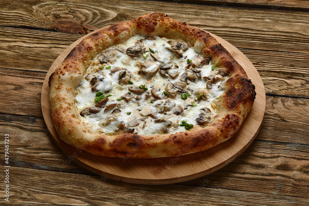 Delicious homemade pizza with mozzarella, mushrooms, beef and chicken. Wooden background, selective focus.
