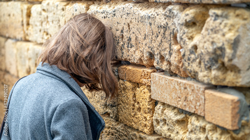 Jewish tourist prays in the wailing wall of Jerusalem, Israel photo