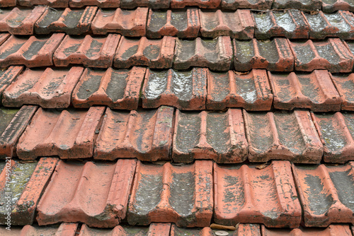 Seamless roof texture of flat red shingles with embedded line patterns.