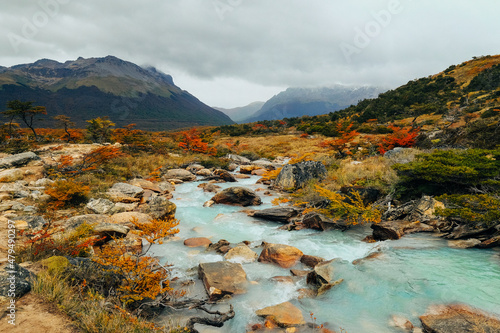 Gorgeous landscape of Patagonia's Tierra del Fuego National Park in Autumn, Argentin turquoise mountain river and autumn forest