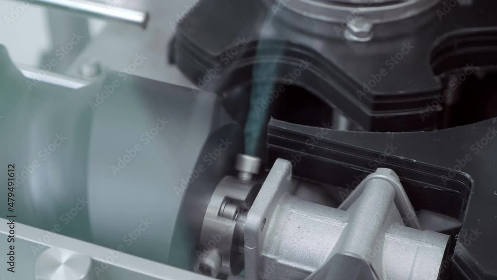 In industrial manufacture - the structure of a worm gear for moving cans on a conveyor for filling drinks in aluminum cans. Shot in motion. Closeup In industrial manufacture - the structure of a worm gear for moving cans on a conveyor for filling drinks in aluminum cans. Shot in motion. Closeup