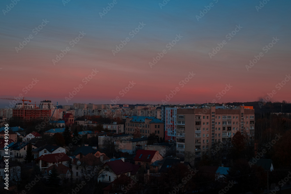 poor city landmark aerial urban view of Eastern Europe third world country with old buildings apartment in dramatic purple blue sunset sky