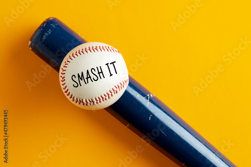 Baseball ball on a bat on yellow background with the word smash it photo