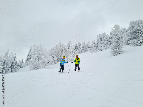 friends skier and snowboarder powder day