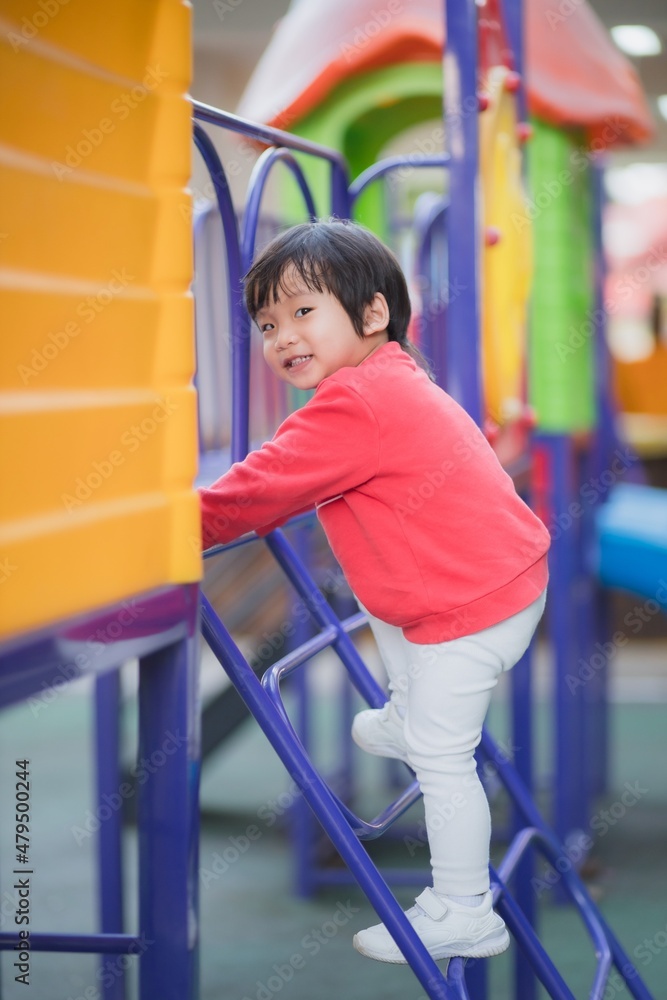 Fototapeta premium Child playing on outdoor playground.