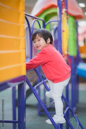 Child playing on outdoor playground.