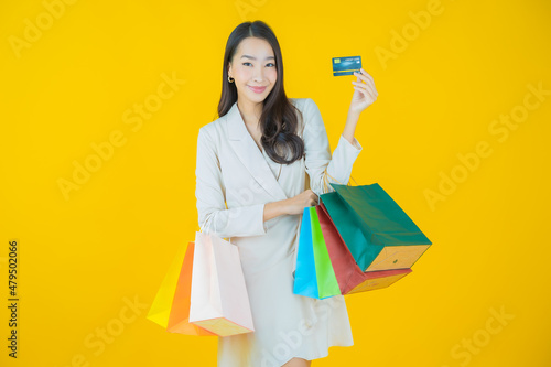 Portrait beautiful young asian woman smile with shopping bag