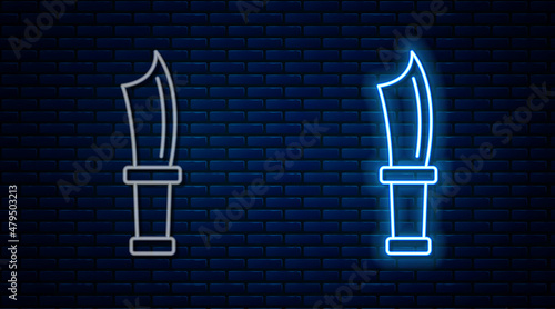 Glowing neon line Diving knife icon isolated on brick wall background. Vector